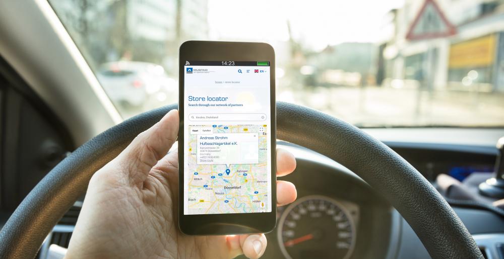 The Mustad store locator on a mobile phone in a car